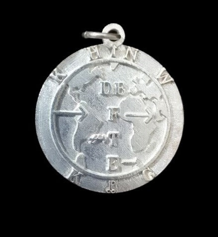 Handcrafted silver Lord's Prayer pendant showing intricate 3D engraved text